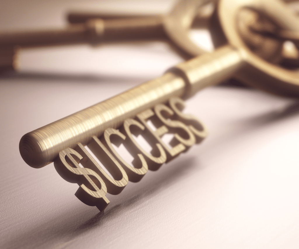 A gold key with the word success at the end.