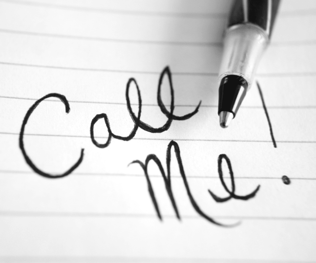 Handwritten note that says "call me" with a black and white pen